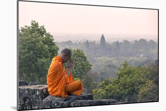 Cambodia, Siem Reap, Angkor Wat Complex. Monk Meditating with Angor Wat Temple in the Background-Matteo Colombo-Mounted Photographic Print