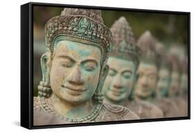 Cambodia, Siem Reap, carved statues at Buddhist temple.-Merrill Images-Framed Stretched Canvas