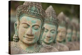 Cambodia, Siem Reap, carved statues at Buddhist temple.-Merrill Images-Stretched Canvas