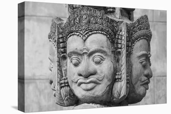 Cambodia, Siem Reap, carved statues at Buddhist temple.-Merrill Images-Stretched Canvas