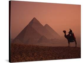 Camel and Rider at Giza Pyramids, UNESCO World Heritage Site, Giza, Cairo, Egypt-Howell Michael-Stretched Canvas