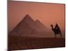 Camel and Rider at Giza Pyramids, UNESCO World Heritage Site, Giza, Cairo, Egypt-Howell Michael-Mounted Photographic Print