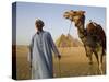 Camel Driver Stands in Front of the Pyramids at Giza, Egypt-Julian Love-Stretched Canvas