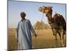 Camel Driver Stands in Front of the Pyramids at Giza, Egypt-Julian Love-Mounted Photographic Print