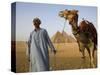 Camel Driver Stands in Front of the Pyramids at Giza, Egypt-Julian Love-Stretched Canvas