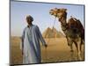 Camel Driver Stands in Front of the Pyramids at Giza, Egypt-Julian Love-Mounted Photographic Print