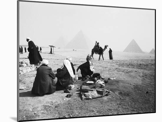 Camel Jockeys at the Giza Pyramids, Cairo, Egypt-Walter Bibikow-Mounted Premium Photographic Print