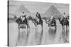 Camels with Native Riders on Board Stand in Reflective Floodwaters-null-Stretched Canvas