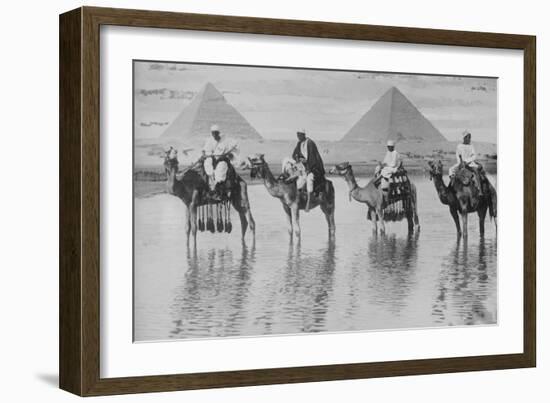 Camels with Native Riders on Board Stand in Reflective Floodwaters-null-Framed Art Print