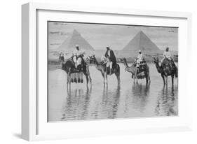 Camels with Native Riders on Board Stand in Reflective Floodwaters-null-Framed Art Print