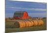 Canada, Alberta, Grande Prairie. Red Barn and Hay Bales at Sunset-Jaynes Gallery-Mounted Photographic Print