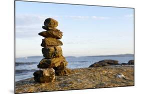 Canada, British Columbia, Russell Island. Rock Inukshuk in front of Salt Spring Island.-Kevin Oke-Mounted Photographic Print