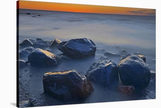 Canada, Manitoba, Winnipeg. Waves on shoreline rocks of Lake Winnipeg at dusk.-Jaynes Gallery-Stretched Canvas