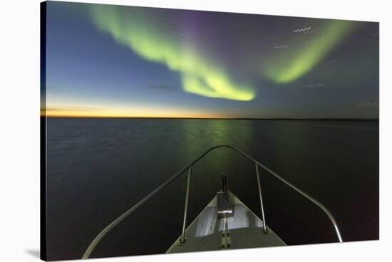 Canada, Nunavut, Aurora Borealis Glows in Night Sky Above Hudson Bay-Paul Souders-Stretched Canvas