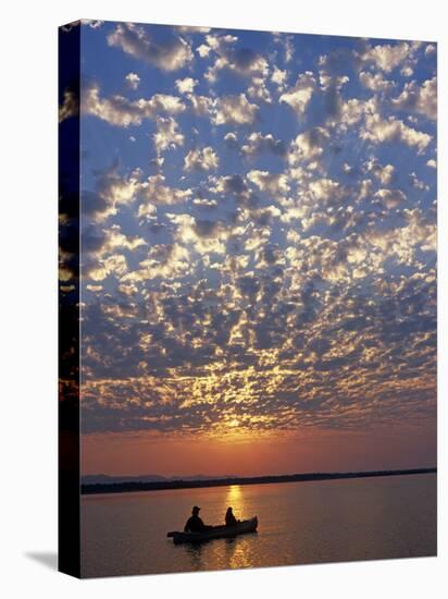 Canoeing under a Mackerel Sky at Dawn on the Zambezi River, Zambia-John Warburton-lee-Stretched Canvas