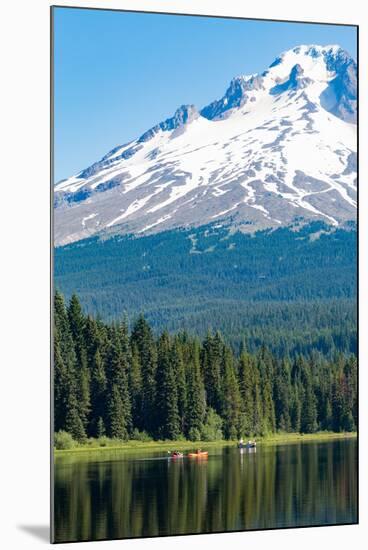 Canoes and rowboat on the still waters of Trillium Lake with Mount Hood, part of the Cascade Range,-Martin Child-Mounted Photographic Print