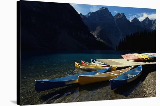 Canoes at Moraine Lake in Banff-W. Perry Conway-Stretched Canvas