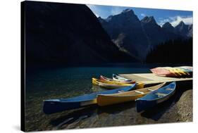 Canoes at Moraine Lake in Banff-W. Perry Conway-Stretched Canvas