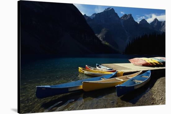 Canoes at Moraine Lake in Banff-W. Perry Conway-Stretched Canvas