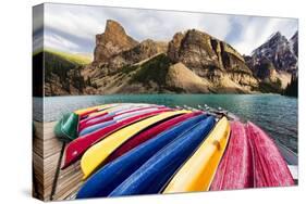 Canoes on a Dock, Alberta, Canada-George Oze-Stretched Canvas