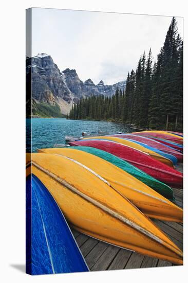 Canoes on a Dock, Moraine Lake, Canada-George Oze-Stretched Canvas