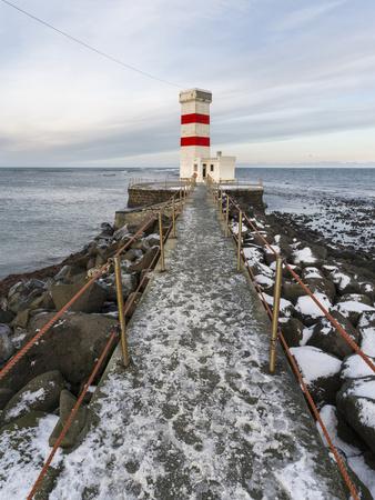 https://imgc.allpostersimages.com/img/posters/cape-gardskagi-with-lighthouse-during-winter-on-the-reykjanes-peninsula-iceland_u-L-Q13AQLN0.jpg?artPerspective=n