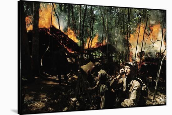 Captain Vernon Gillespie Contacting His Base Camp While Vietnamese Soldiers Burn Viet Cong Hideout-Larry Burrows-Stretched Canvas