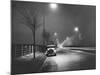 Car on a Lit Road-null-Mounted Photographic Print