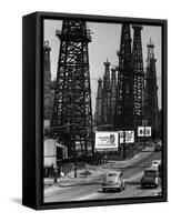 Car Traffic on Highway Next to Advertising Billboards and Oil Well Towers, Signal Hill Oil Field-Andreas Feininger-Framed Stretched Canvas