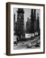 Car Traffic on Highway Next to Advertising Billboards and Oil Well Towers, Signal Hill Oil Field-Andreas Feininger-Framed Photographic Print