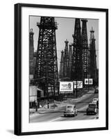 Car Traffic on Highway Next to Advertising Billboards and Oil Well Towers, Signal Hill Oil Field-Andreas Feininger-Framed Photographic Print