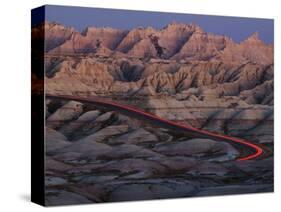 Car Traveling Through Badlands National Park-Layne Kennedy-Stretched Canvas