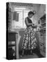 Career Girl Hostedd Joan Wilson in skirt and sleeveless blouse cooking in kitchen-Nina Leen-Stretched Canvas