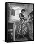 Career Girl Hostedd Joan Wilson in skirt and sleeveless blouse cooking in kitchen-Nina Leen-Framed Stretched Canvas