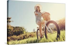 Carefree Woman Riding Bicycle in Park Having Fun on Summer Afternoon-warrengoldswain-Stretched Canvas