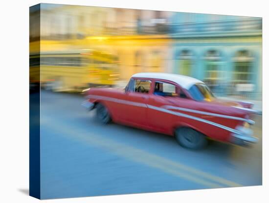 Caribbean, Cuba, Havana, Havana Vieja, UNESCO World Heritage Site, classic car in motion-Merrill Images-Stretched Canvas