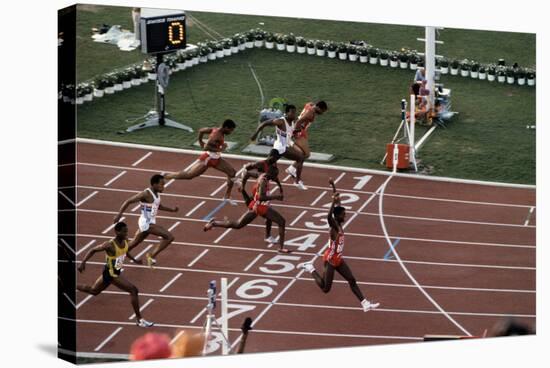 Carl Lewis Crosses the Finishing Line at the Los Angeles Olympics-null-Stretched Canvas