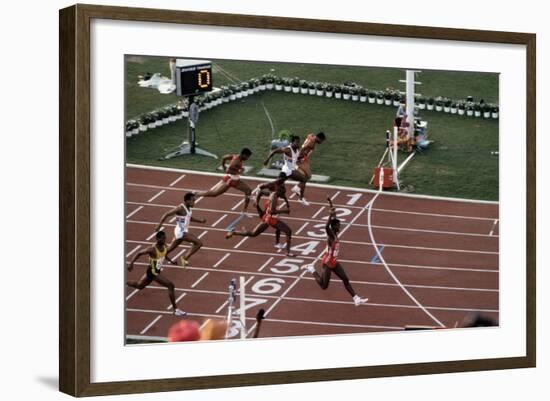 Carl Lewis Crosses the Finishing Line at the Los Angeles Olympics-null-Framed Photographic Print