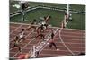 Carl Lewis Crosses the Finishing Line at the Los Angeles Olympics-null-Mounted Photographic Print