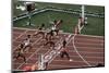 Carl Lewis Crosses the Finishing Line at the Los Angeles Olympics-null-Mounted Photographic Print