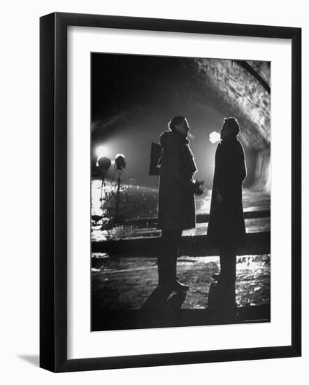 Carol Reed Coaching Orson Welles as They Stand Against Floodlights During Filming "The Third Man."-William Sumits-Framed Premium Photographic Print