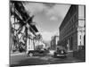 Cars Crossing an Intersection on a Downtown Honolulu Street with Mountains in the Background-null-Mounted Photographic Print