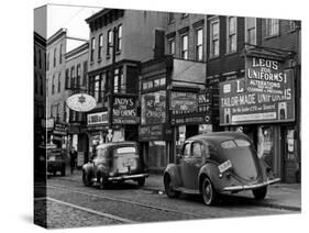 Cars Parked in Front of Four Navy Uniform Stores on Sand Street-Andreas Feininger-Stretched Canvas