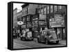 Cars Parked in Front of Four Navy Uniform Stores on Sand Street-Andreas Feininger-Framed Stretched Canvas