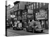 Cars Parked in Front of Four Navy Uniform Stores on Sand Street-Andreas Feininger-Stretched Canvas