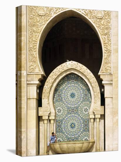 Casablanca a Visitor Is Dwarfed by the Towering Mosaic Tilework of the Hassan Ii Mosque, Morocco-Andrew Watson-Stretched Canvas