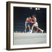 Cassius Clay, aka Muhammad Ali Throwing Famous "Phantom Punch"-George Silk-Framed Premium Photographic Print