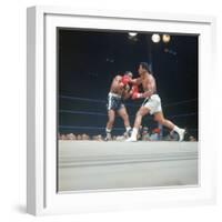 Cassius Clay, aka Muhammad Ali Throwing Famous "Phantom Punch"-George Silk-Framed Premium Photographic Print