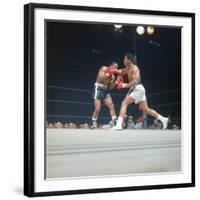 Cassius Clay, aka Muhammad Ali Throwing Famous "Phantom Punch"-George Silk-Framed Premium Photographic Print