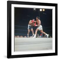 Cassius Clay, aka Muhammad Ali Throwing Famous "Phantom Punch"-George Silk-Framed Premium Photographic Print